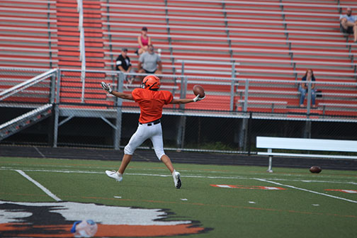 After scoring a touchdown during a scrimmage, JV football player celebrates. The Jv team doesnt scrimmage the Freshman team often but when they do, they enjoy it.