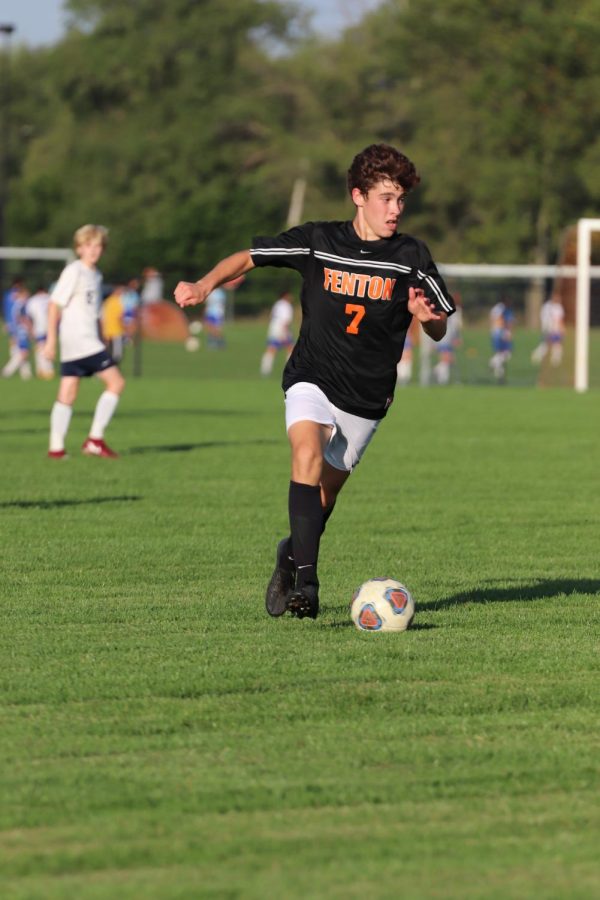 Sophomore Zachary Dawes dribbles the ball down the field in an attempt to score a goal against Goodrich. Fenton lost this game 1-0 on Sept 16. 
