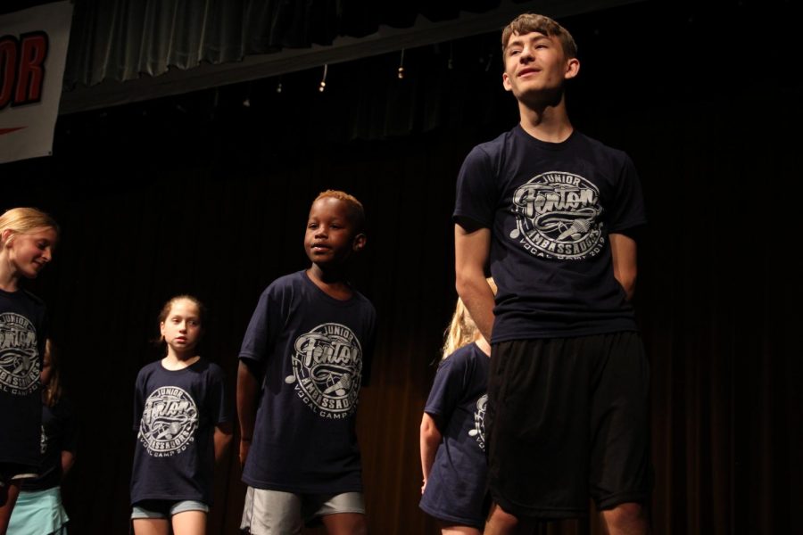 Leading the campers in a song, junior Chris Lefave sings with his friends. The Ambassadors volunteered at the Jr. Ambassadors camp the week of June 23.