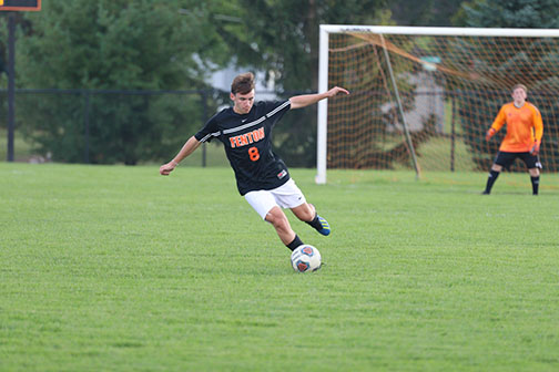 Sophomore Chase Gibson kicks a ball to his teammates so they can score. The JV team played against Kearsley on 9/16/19 and lost 0-1.