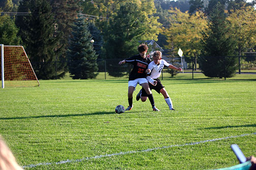 Defending his teams goal, freshman Gabe Grigorian fights to win the ball. On Sept. 30, the JV boys soccer team played Flushing for their last home game and won 2-0.