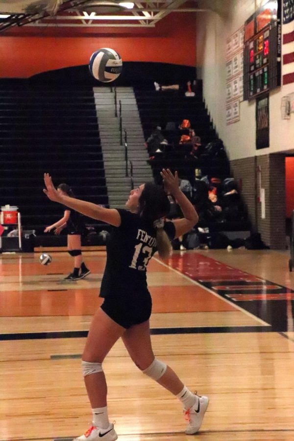 Serving the ball, freshman Keegan Weddle along with the freshman team, fights to beat their biggest rival Linden. On Oct. 22, the Fenton freshman volleyball team beat Linden in all three of the matches. 