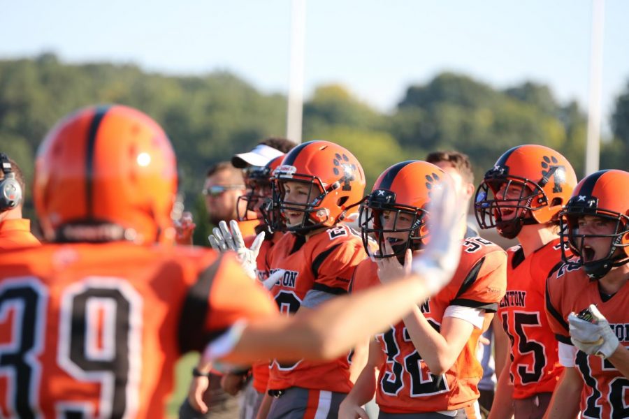 The Fenton Tiger football team celebrated as Mason Canterbury made a touchdown. The team played Holly Sept. 19.