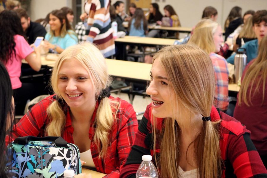 For homecoming week, Junior Brooklyn Aherne and Sophomore Chloe Couch laugh at lunch. On Oct. 10 they participated in farmers day. 