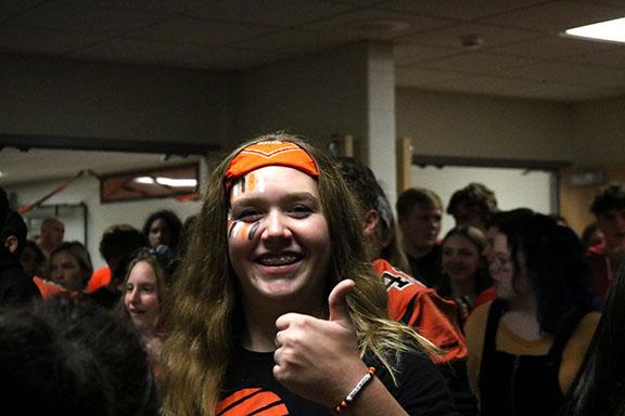 Excited to attend her first pep assembly, freshman Erin McVey poses for a picture. On Oct. 11, the Fenton High School students wore orange and black to represent their tiger pride for their final homecoming spirit day of 2019.