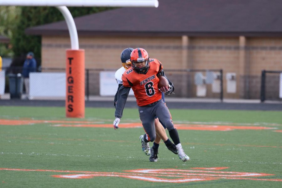Running the ball down the field, freshman Mason Canterbury attempts to get his team a first down. On Oct. 17, Fentons freshman football team lost to Grand Ledge High School.
