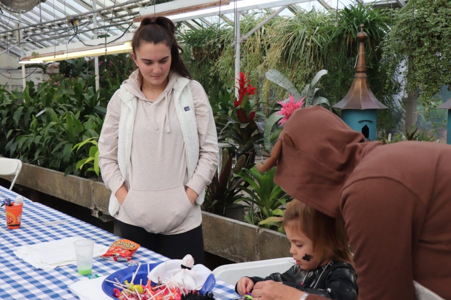 Senior Olivia Battaglia helps a child with arts and crafts at Gerychs. On Oct. 26 National Honors society volunteered at Gerychs Kids Day where children could play games, make crafts and eat food. 