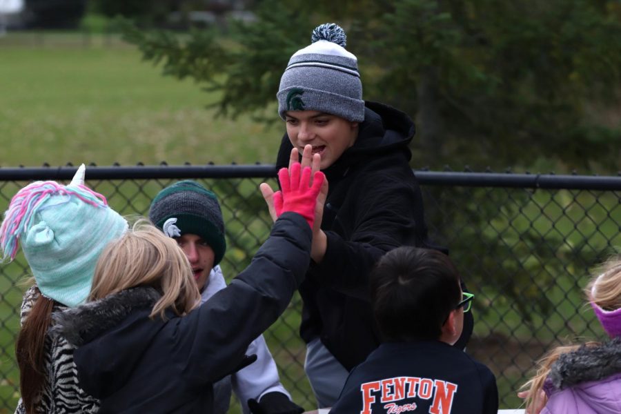 After completing the activity, sophmore Seth Logan high fives his State Road buddy. On Oct. 17 the high school hosted the elementary schools for the semianual pond day. 