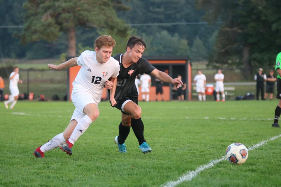 Senior Alex Flannery lunges around a player during a game against South Lyon.
