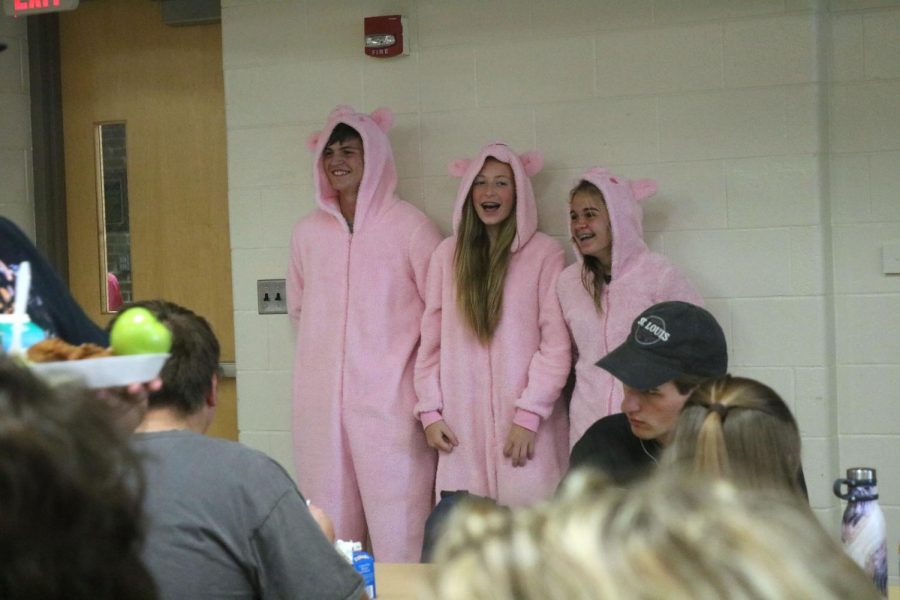 Sophomores, Rylan Sheffield, Blake Baird, and Alexis Freeman celebrate Cartoon day on Oct 9. by wearing twinning pig onesies. The sophomores stood up by the wall to take a picture, but couldnt stay serious. 