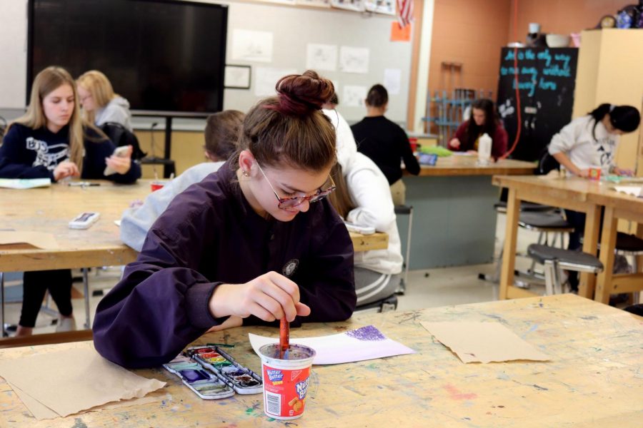 Junior Coral Lefever focuses on her art project. On Nov. 1, sculpture and drawing students used watercolor to make an abstract painting. 