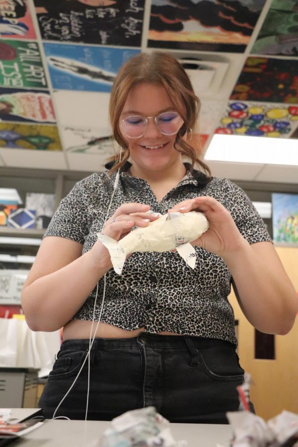 In her art class, senior Sarah Dziadzio, works to make her sculpture come to life. Dziadzio smiled with enjoyment as she finished what she was creating.