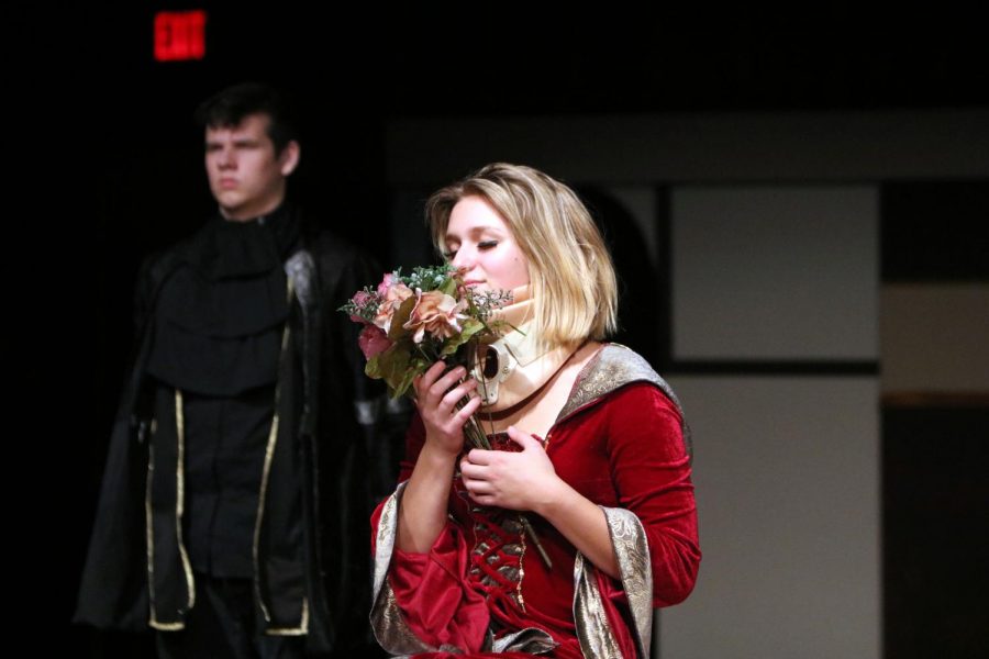 Regina George, played by senior Sheehan Personett, smells her bouquet of flowers she receives after her accident.  Much Ado About Mean Girls was a Shakespearean twist to the original Mean Girls which was an all-school play that took place on Nov. 7-9.