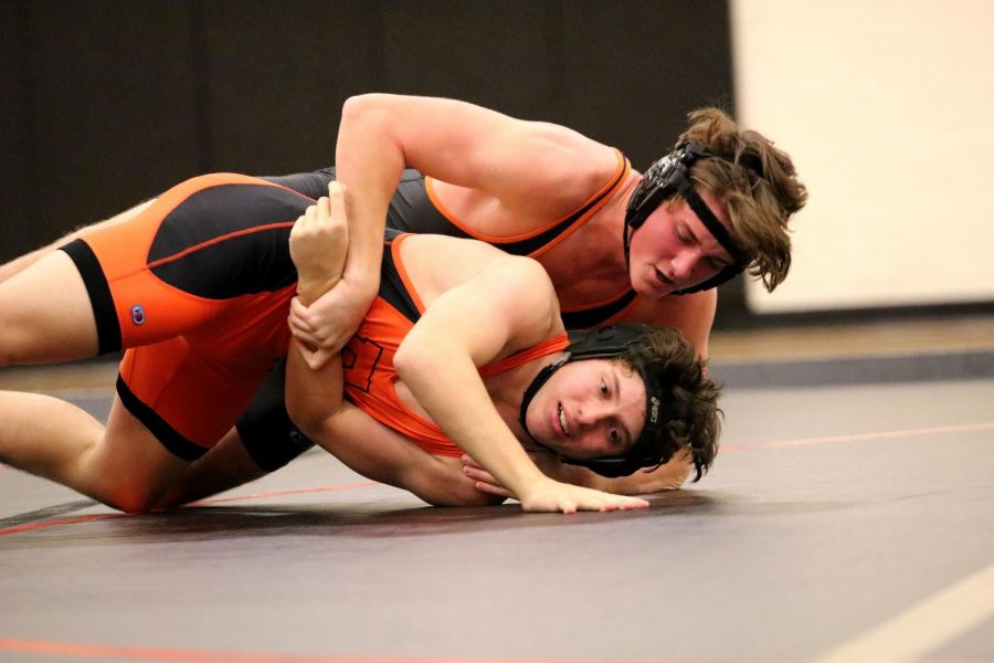 Sophomore Ethan Barancik tries to pin junior Garrett Langford during the Fenton Wrestling teams intersquad meet. On Dec. 4 the Fenton wrestling team participated in an intersquad meet where the wrestlers competed against other wrestlers on their team. 