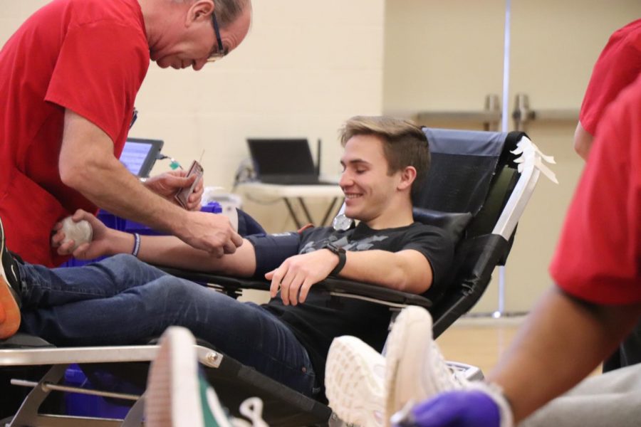 As he prepares to get his blood drawn, senior Owen Koza smiles in anticipation. The blood drive was hosted by Fenton High on Jan. 10, as National Honor Society members and the Red Cross collaborated together. 