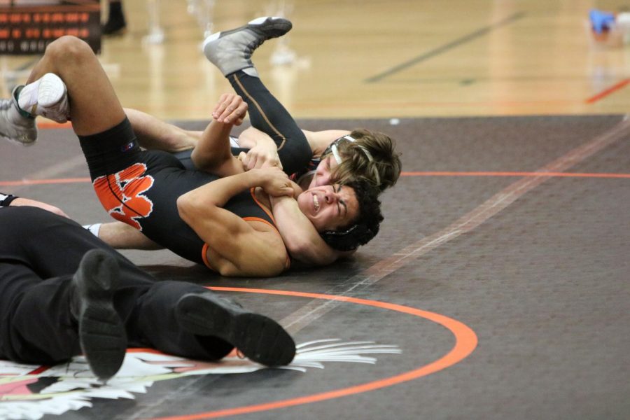 Freshman Mason Canterbury struggles as he wrestles his opponent from Linden. On Jan. 29, Fenton hosted a meet for 4 other schools. 