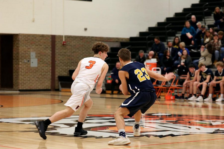 Sophomore+Calvin+Curtis+dribbles+the+ball+to+the+basket+from+the+defender.+On+Jan.+7%2C+the+Fenton+Tigers+JV+boys+basketball+team+won+against+Goodrich.+