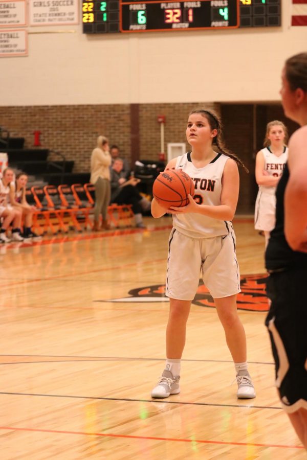 Preparing to shoot her free throws, freshman Abby Logan concentrates on the basket. On Jan. 16 the girls JV basketball team beat the Linden Eagles.