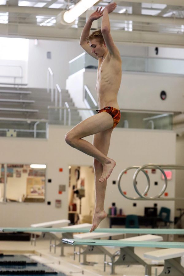 Perfecting his diving form, sophomore Justin Miller tries to execute a tuck dive. The swim boys are preparing for a meet against multiple schools on Feb 27. 