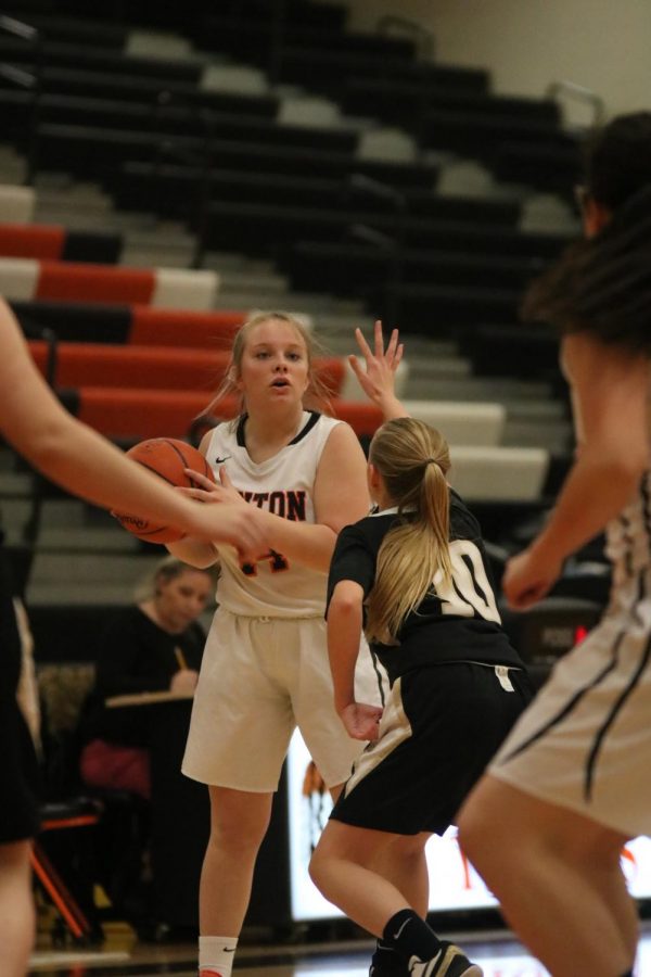 Sophomore Dylyn Nichols looks to find a teammate to pass to. On Feb. 4 the JV basketball team played against Corunna and won, adding to their 8-6 winning record. 