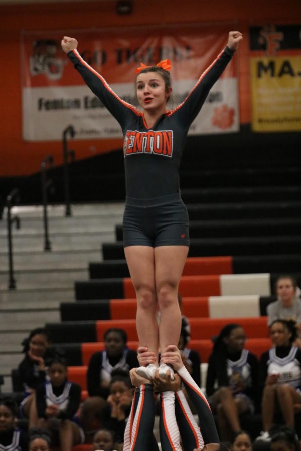Junior Hailey Morcom is held above her teammates head in triumph at the end of Fenton Cheers rueten. Morcom and her team finished 2nd on Feb 8.