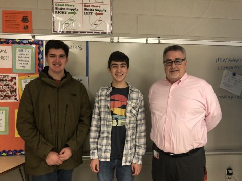 From left to right, co-founders of the Economic Club junior Joseph Henley and Aaron Toth smile next to their teacher sponsor Kevin Crimmins. 