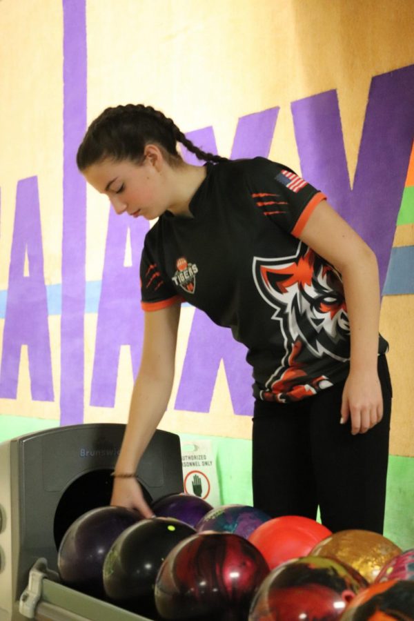 Sophomore Ella Cox grabs her bowling ball as she prepares to bowl her next frame. On Feb. 1 the girls bowling team faced Kearsley.