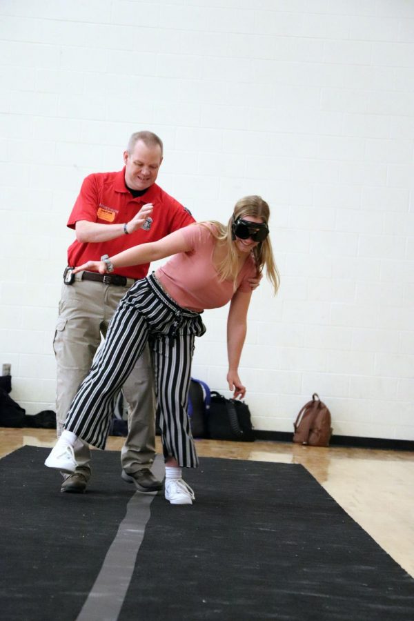 Senior Julia Young stumbles as she tries to walk in a straight line. On Feb. 7, teacher Matthew Sullivan had his class perform a drunk goggles lab. 