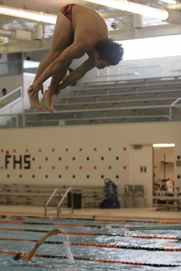 Sophomore Lucas Shampo dives into the water at swim practice on Feb. 19. The boys swim team practices twice everyday at the FHS pool.