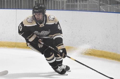 Tristyn Cox slices through the ice on Honeybaked hockey team