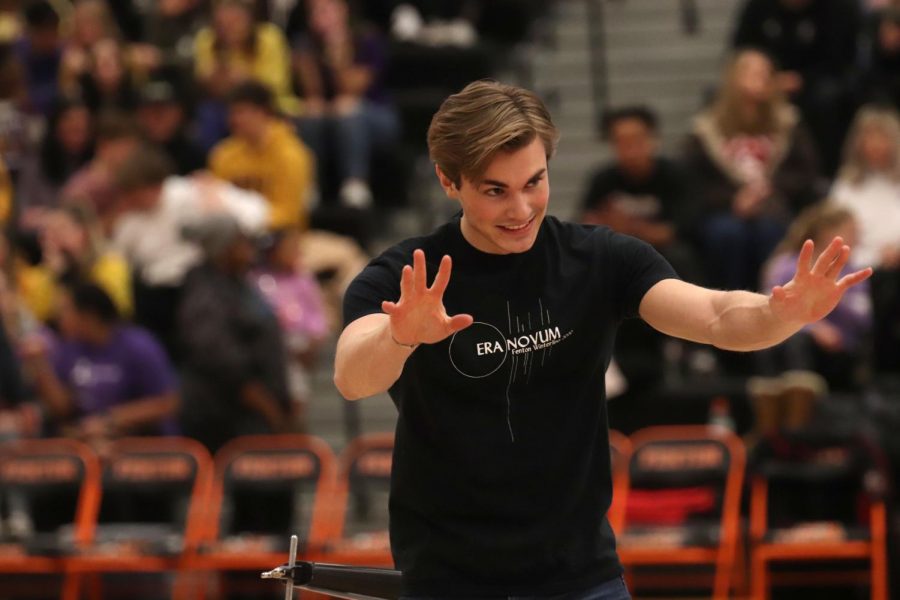 After performingwoth the drumline, senior Andrew Donar waves to the audience. The drumline perfomed during both the girls and boys varsity basketball games on Jan. 31.