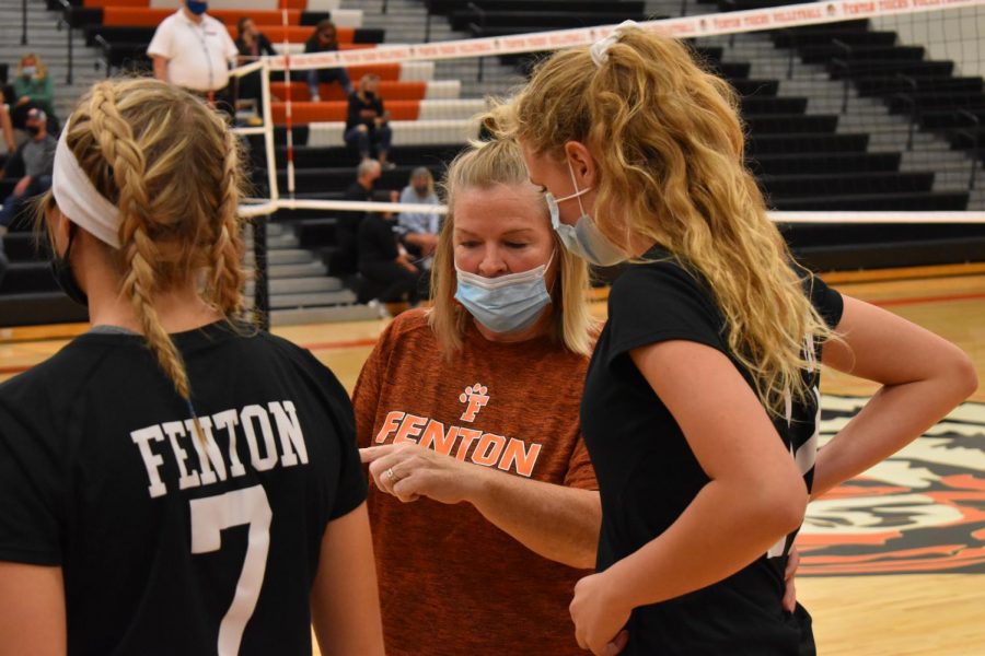 Coach Laurie Thompson discusses play with freshman Anneliese Thisse during a home game on Sept. 14. The Tigers beat the Broncos in a clean sweep 3-0.