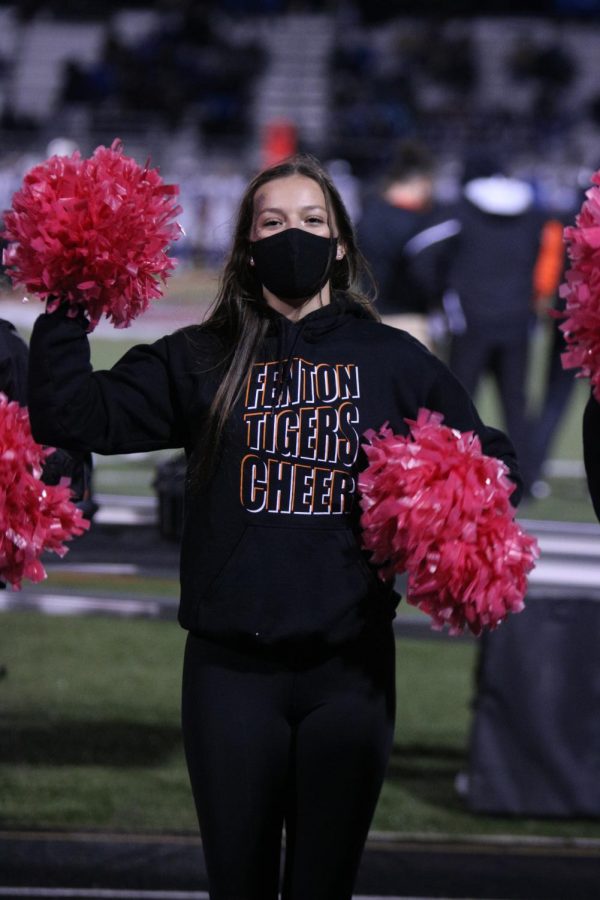 Senior Taylor Wire cheers for the Fenton varsity football team. On Oct. 23 the Tigers beat the Blackhawks 32-21. 