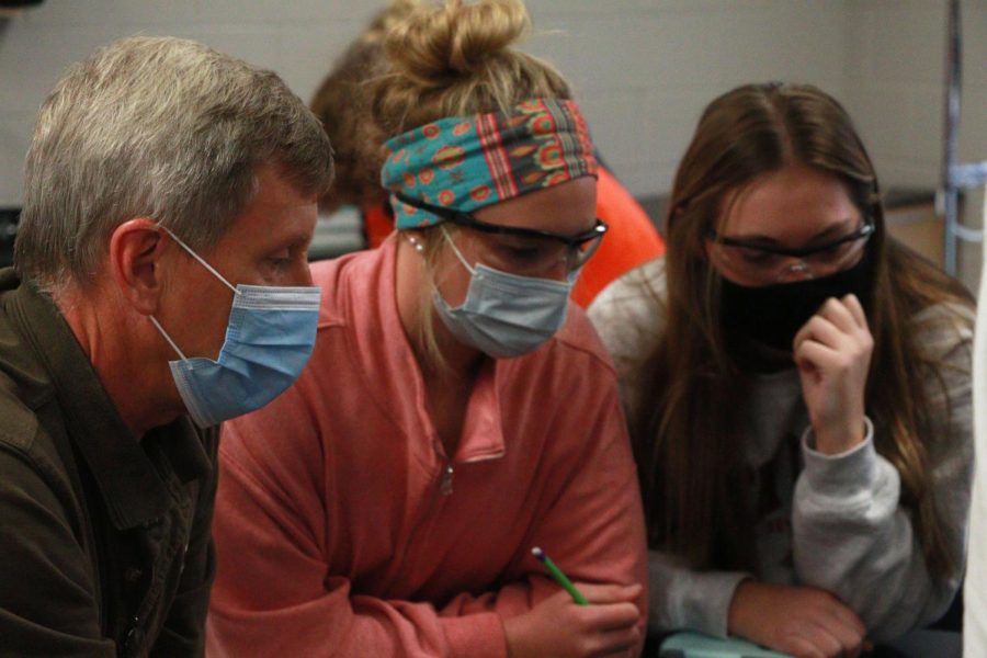 Teacher Mr.Ellis helps sophomores Tammy Craven and April Carr with a science lab in Ms.Shulters biology class on Nov. 11. 
