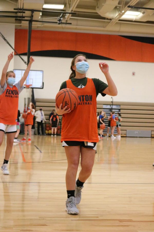 During this hard time Allie Mowerly, Freshman is laughing along side of her friends while shooting at the start of Freshman Basketballs practice. Practicing on Feb 1st they are hoping for the opportunity to play their first high school game this year.
