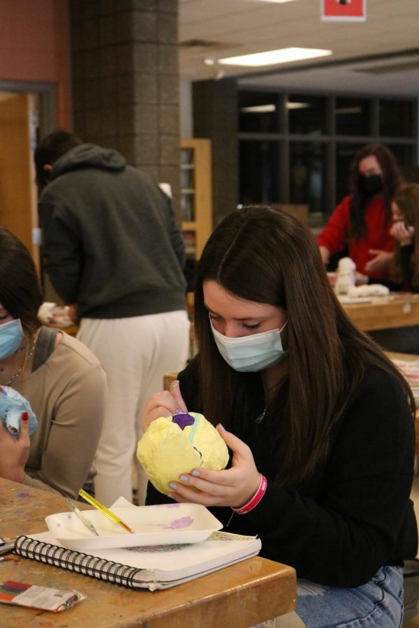 Sophomore Gena Duffy works on painting her art project. Fenton art classes have been working on paper mache animals.