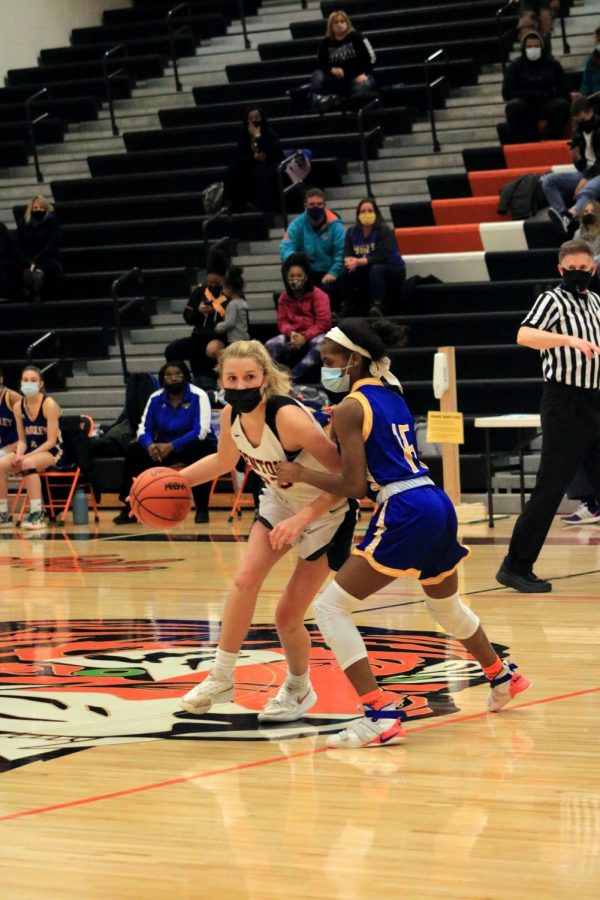 Senior Korryn Smith dribbles the ball past her opponent from Kearsley on Feb. 19th. The Tigers later beat Kearsley. 