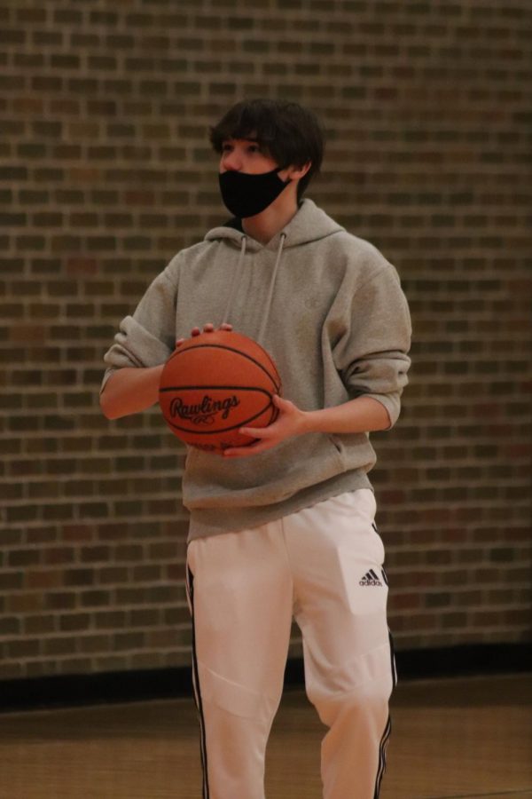 Sophomore Jack Horne is eyeing the basket, ready to make his next shot during second hour gym class on February 18th.  