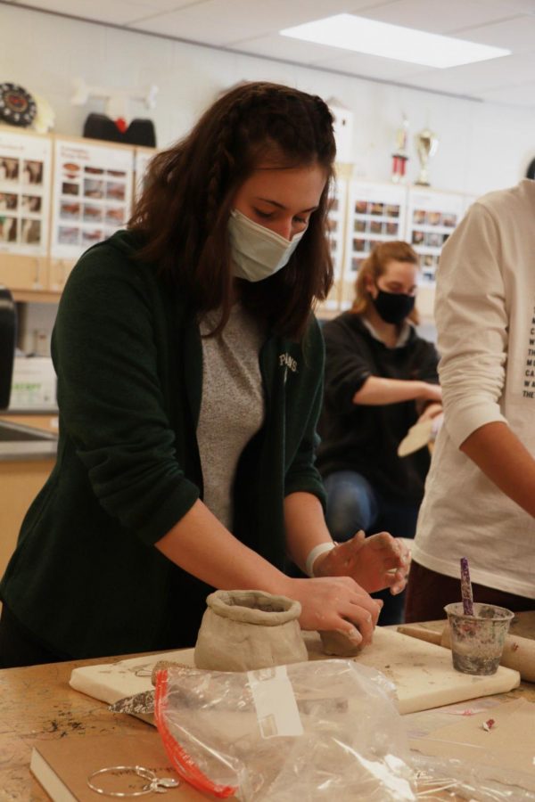 Sophomore Maddie Burnau rolls out her clay. Mrs. Jambeck gave her art students creative freedom (I THINK- you might have to fix this) during their pottery unit.