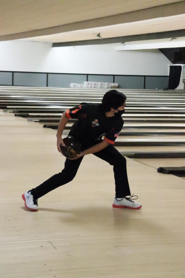 Stepping up to the lane, senior Jake Durant gets ready to bowl his frame. On Mar. 6 the Fenton bowling team had a meet at Holly Lanes. 
