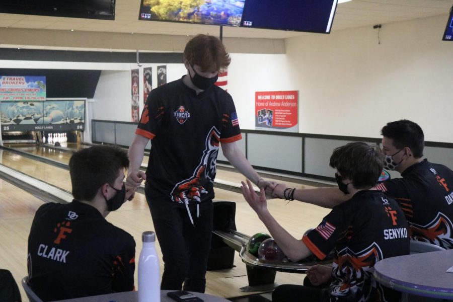After bowling his frame, junior Andrew Hutchins gets congratulated by his teammates. On Mar. 22 the JV bowling team had a match at Holly lanes.  