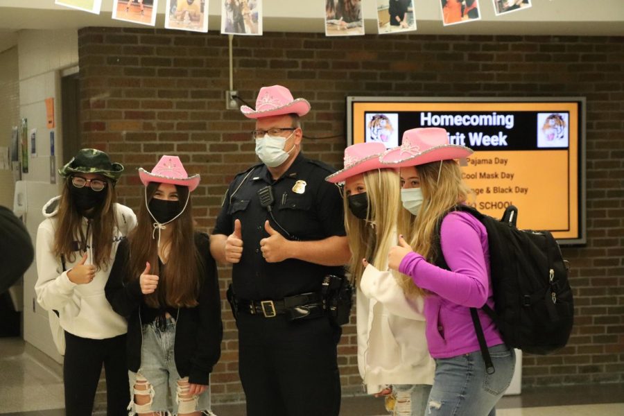 Officer Cole and freshman girls dress up for spirit week. April 30 was western day at Fenton High School. 