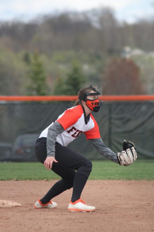 Ready on the infield, freshman Allie Michewicz focuses on the ball. On April 16 the JV softball team defeated the Swartz Creek Dragons in a double header. 