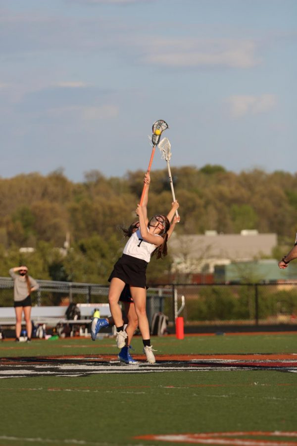 Senior Hannah Ludwig catches the ball in an intense game against Midland on Friday May 14. The lacrosse team is a mixture of Fenton and Linden students.