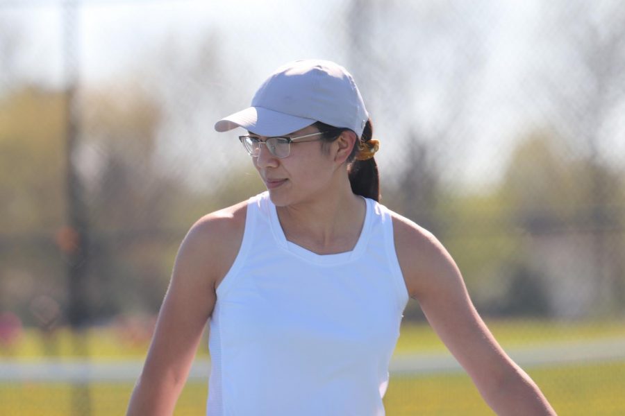 Junior Elizabeth Borg glances across the court before making a serve. On April 30, the girls varsity tennis team played Owosso at home.