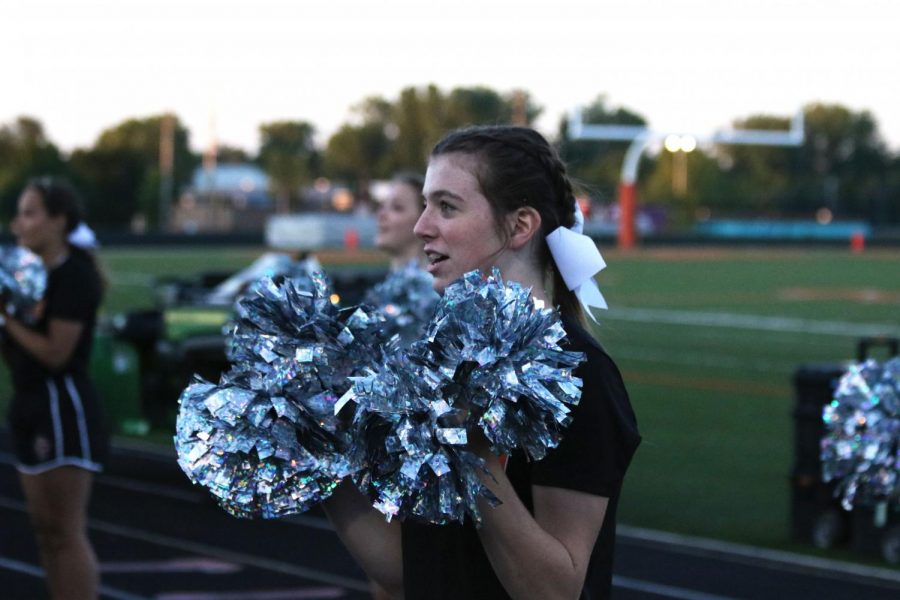 Freshman Sophia Markley cheers for the Fenton Tigers. The cheer team kept the spirits up on Sept. 2 when the JV football team played East Lansing. 