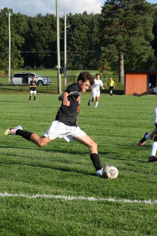 Sophomore Nickolas Danely kicks the ball to his offensive teammates. On Sept. 15 the Tigers lost 1-3.