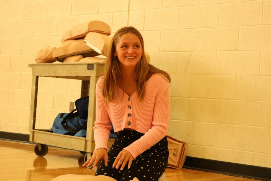 Freshman Addison Dolliver performing CPR for her gym class she learned to make sure to check the person before giving them CPR.