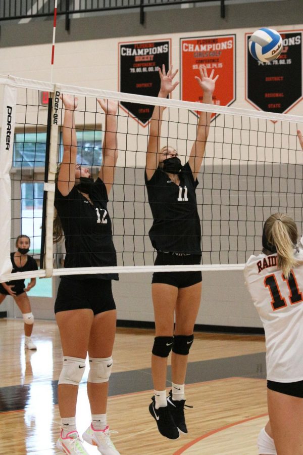 On Sept 9, Freshmen Kaylee Kaluza and Alexandria Shouse block a Flushing hitter during the first set of the match, winning 25-20. The Tigers played their first game of the season, beating the Raiders in all three sets, and starting the season off with a 1-0 record.  