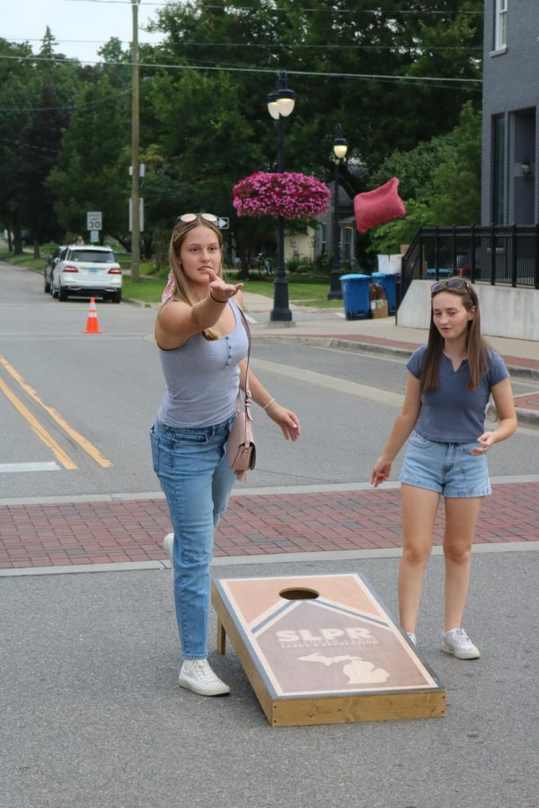 In a game of cornhole, Junior Emily K throws the bean-bag against opponent Junior Paige Javor. On Aug 5. Fenton closed down the roads for the annual thursday night farmers market. 